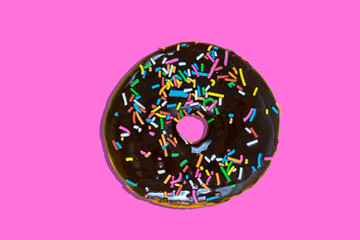 Sweet donut with icing on pink background