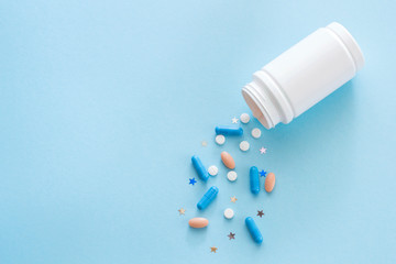 Magic tablets and capsules and bottle. Copy space for text, top view. Colorful antidepressants