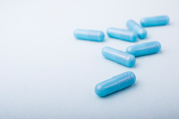 Blue pills macro on blue background 
