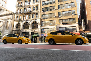 Yellow cars near city buildings