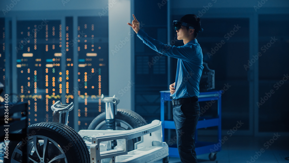 Aufkleber automotive engineer working on electric car chassis platform, using augmented reality headset with t