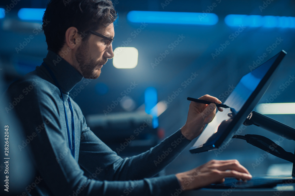 Leinwandbilder Professional Automotive Graphic Designer is Working on Concept Car Render with a Stylus Pen in a High Tech Innovative Laboratory with a Prototype Car Chassis.