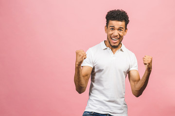 Afro american winner! Handsome attractive manly cheerful glad man, showing winning yes cool gesture, celebrating, isolated over pink background.