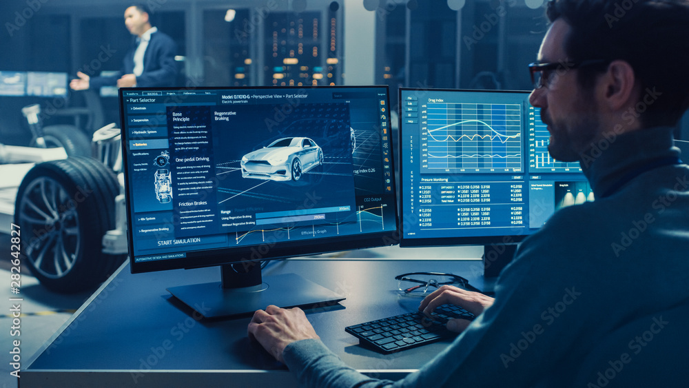 Poster professional engineer works on a computer with a 3d cad software and tests the electric car chassis 