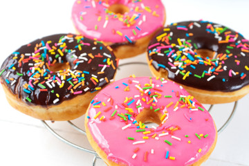 Sweet donuts with icing on white background