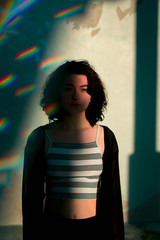 young grunge hipster woman with dramatic shadows and prism rainbow