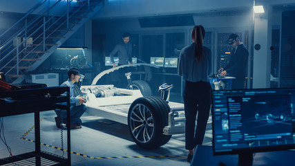 Automotive Design Engineers Work and Do Tests on Electric Car Chassis Prototype. In Innovation...