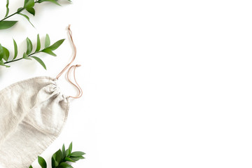 Frame made of ruscus branches and canvas bag on white background