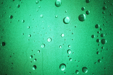 Light shines through a plastic shower door with a bubble-effect surface