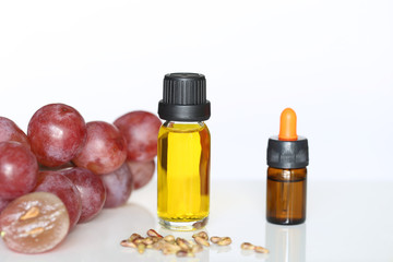 Grape seed oil in glass bottles on white background