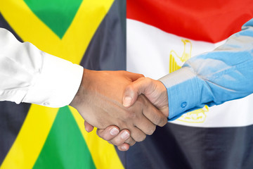 Business handshake on the background of two flags. Men handshake on the background of the Jamaica and Egypt flag. Support concept