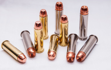 Ten bullets, five .38 special full metal jacket and five .357 magnum ones on a white background