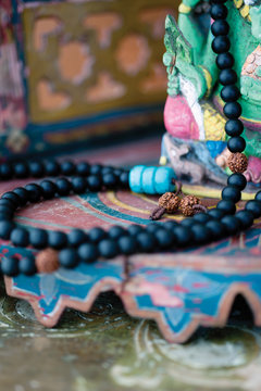 Mantra Mala Resting On A Colorful Altar. 