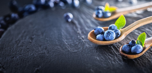 Juicy and Fresh Blueberries with Green Leaves. Concept for Healthy Eating