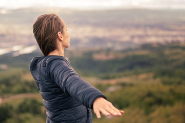 Christian worship and praise. A young woman is praying and worshiping in the evening.