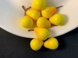 Yellow pears on a black background.