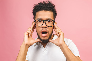 Fototapeta premium Portrait of happy young good-looking tan-skinned male student with afro hairstyle in casual, looking in camera with excited face expression