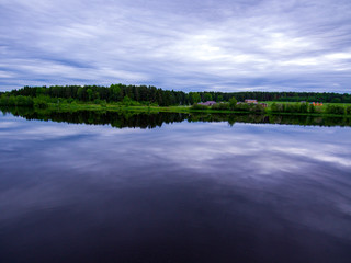 village on the shore of a calm pond