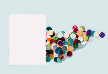 Colorful confetti explosion from envelope on blue background.