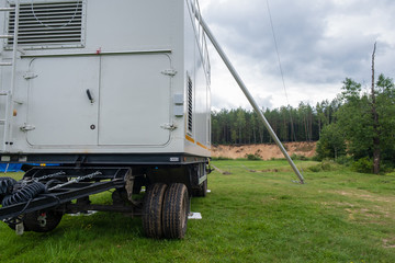 Photo of a cell tower with an electricity generator in the forest