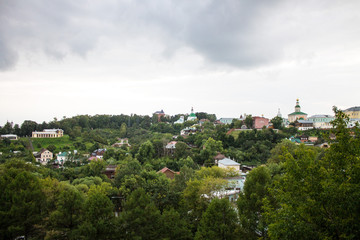 Fototapeta na wymiar Panoramic view of the city of Vladimir, Russia summer a cloudy day on the background of green trees