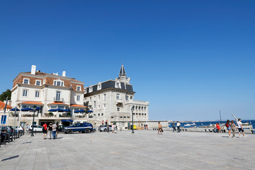 Cascais, Lisbon, Portugal - June 28, 2019: Tourists enjoy Ribeira Beach or Fisherman's Beach, in the center of Cascais, in Lisbon District, in Portugal.