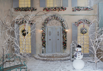 porch of the house with Christmas decorations and snowman