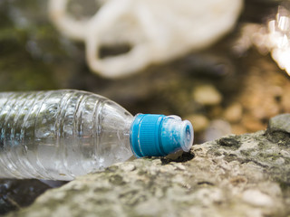 Close-up of waste plastic water bottle at outdoors