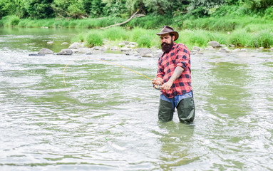 water sport. summer weekend. Happy fly fishing. fisherman show fishing technique use rod. bearded fisher in water. hobby and sport activity. mature man fly fishing. man catching fish