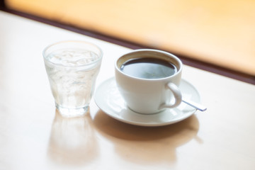 Hot Coffee cup and drink water on the wooden table as beverage background