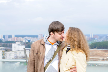 Two lovers kissing in the background of the city