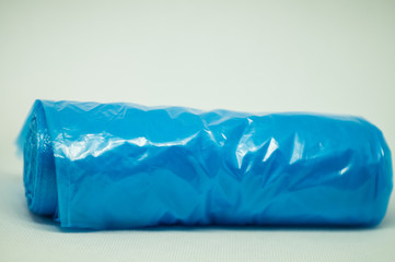 Blue plastic bag for garbage on a white background