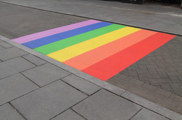 A LGBT Rainbow Painted on a Public Paved Road.