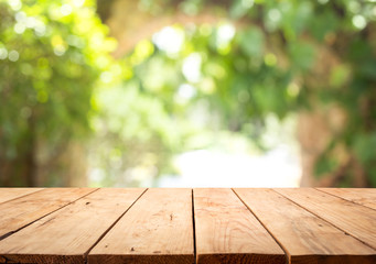 Empty wood table top on blur abstract green from garden and home area background