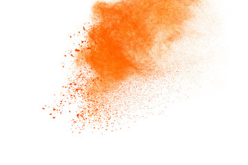 Abstract orange powder explosion. Closeup of orange dust particle splash isolated on white background