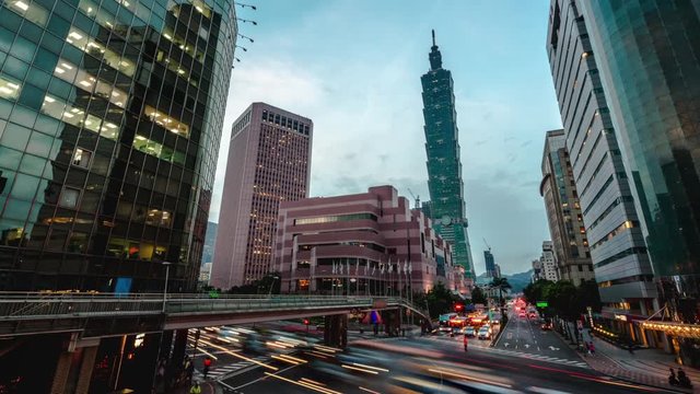 4K, Timelapse overhead view of Taipei main road from day to night with the famous building 101 and traffic car light long exposure photo. Cityscape of street with traffic and pedestrians-Dan