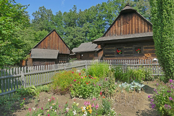 Fototapeta na wymiar Historical wooden farm houses with garden, Wallachian Open Air Museum, Roznov pod Radhostem, Czech Republic