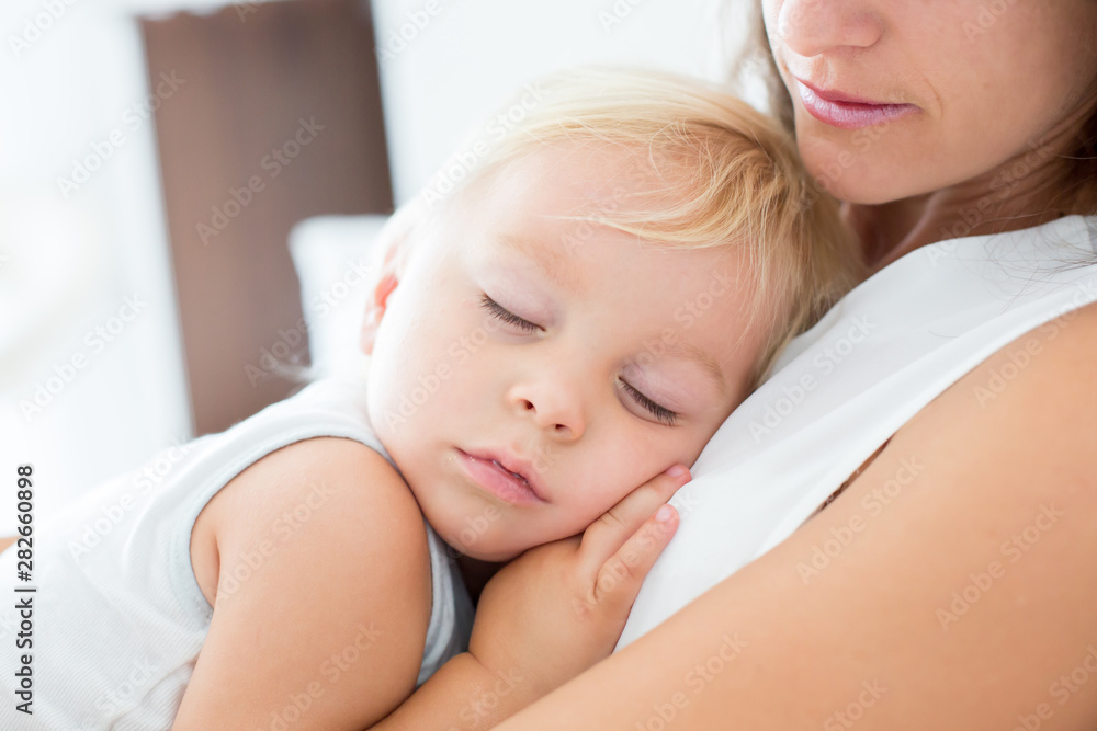 Canvas Prints Young mother lying in bed with her sleeping toddler baby boy