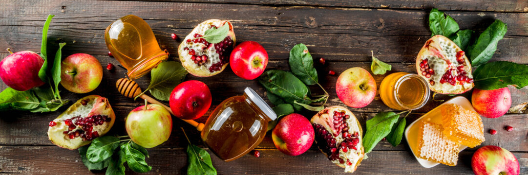 Jewish Autumn Rosh Hashana Celebration. Traditional Products For The Celebration Of Rosh Hashanah - Apples With Leaves, Pomegranate, Honey, Honeycombs, Wooden Background Banner