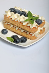 Cakes made from Italian savoyardi cookies and cream. Decorated with blueberries and mint leaves.