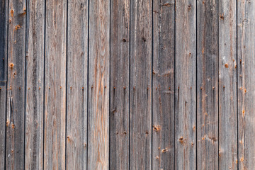 Old shabby worn wooden boards - background, wall of vintage house. Rural texture.