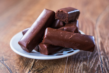 Chocolate cookies on a plate on old wooden table