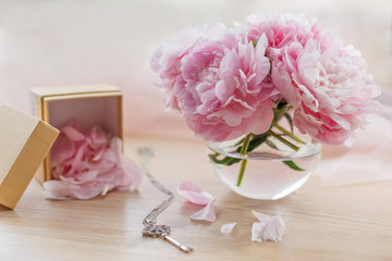 Still life with beautiful pink peonies in glass vase © Natali Illar