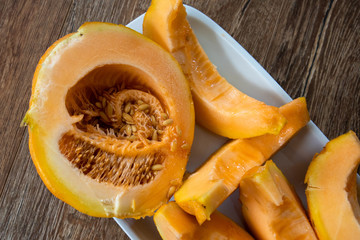 Slices of melon on wooden table
