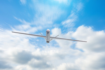 Unmanned military drone flies patrolling the territory the at day clouds sky.