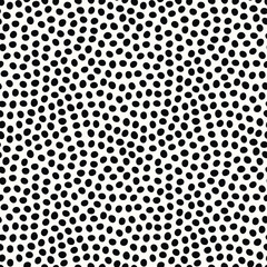 Seamless repeat tossed pattern of hand drawn polka dot. Black spots in an abstract vector design background.