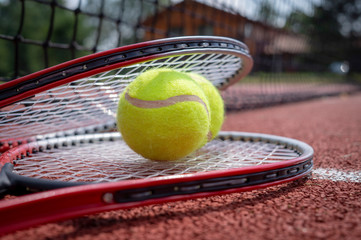 Tennis scene with black net, balls and racquet