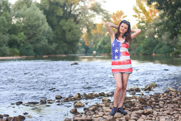 Beautiful middle aged woman on river coast. Older woman enjoy by the river at sunset