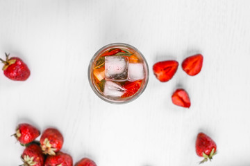 top view of summer cocktail with strawberries and ice. Mojito with strawberries. Top view with copy space.