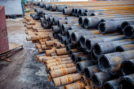 Drill pipe of  oil drilling platforms. Stack of oil well casing bundles at the pin end of casing. Downhole drilling rig